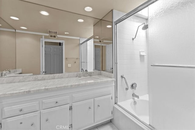 bathroom featuring ornamental molding, shower / bath combination with glass door, and vanity