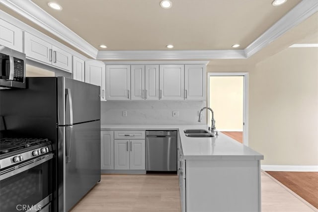 kitchen featuring appliances with stainless steel finishes, light hardwood / wood-style floors, ornamental molding, and white cabinets