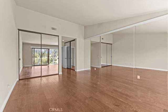 empty room with hardwood / wood-style floors