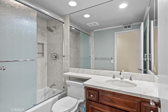 full bathroom with shower / bath combination with glass door, crown molding, vanity, and toilet