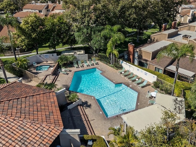 view of pool with a hot tub and a patio area