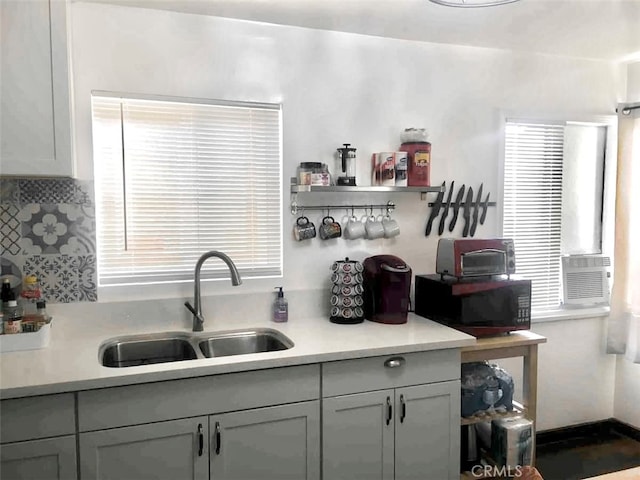 kitchen featuring cooling unit, sink, and gray cabinetry