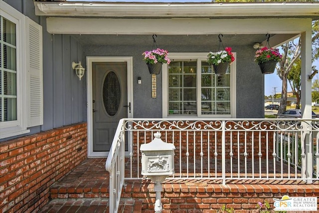 doorway to property featuring covered porch