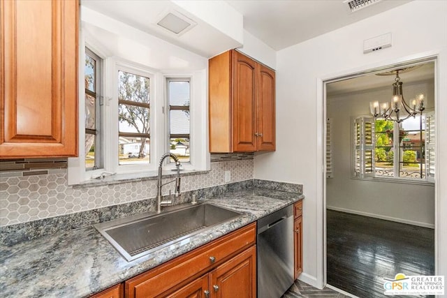 kitchen with a wealth of natural light, dishwasher, sink, and dark hardwood / wood-style flooring