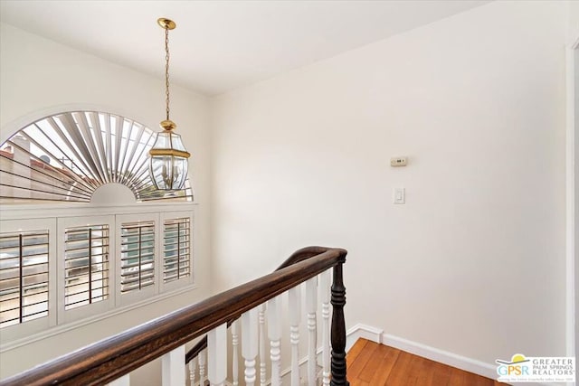 corridor with hardwood / wood-style floors