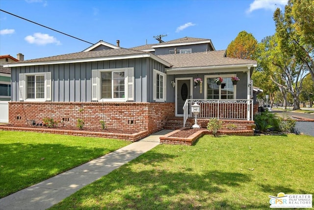 bungalow featuring a front yard and covered porch