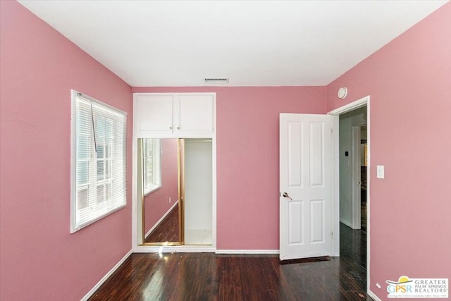 unfurnished bedroom featuring dark wood-type flooring