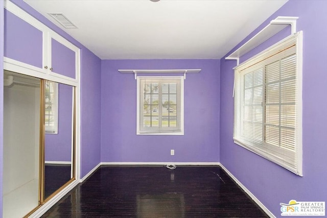 unfurnished bedroom featuring a closet and hardwood / wood-style floors