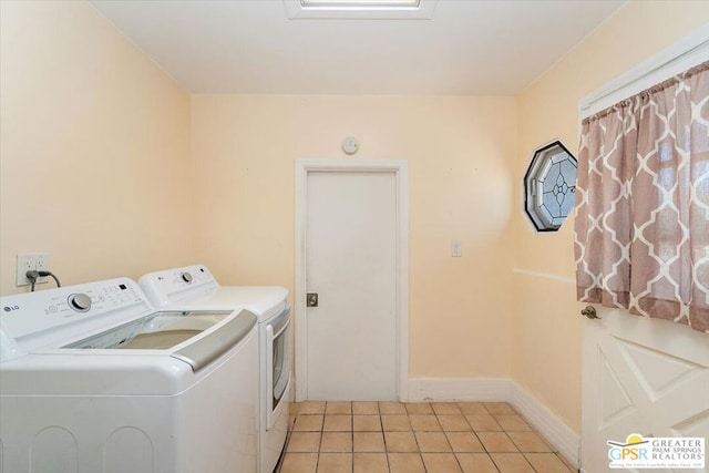 laundry room featuring separate washer and dryer and light tile patterned floors