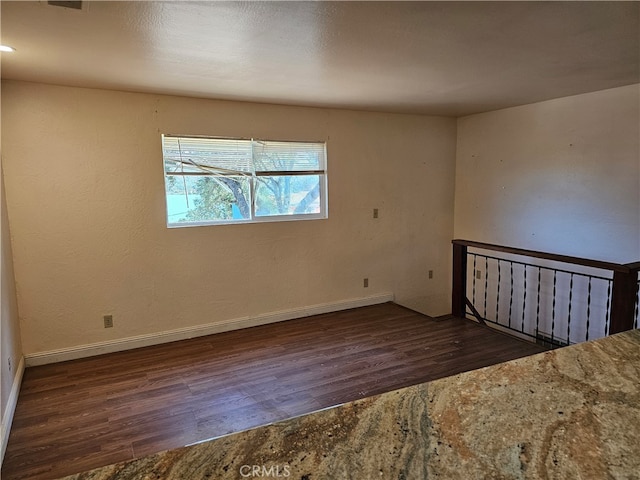 empty room featuring dark wood-type flooring