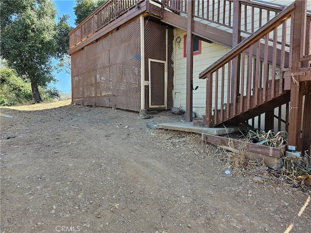 view of side of home with a wooden deck