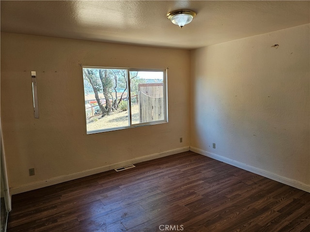 empty room featuring dark hardwood / wood-style flooring