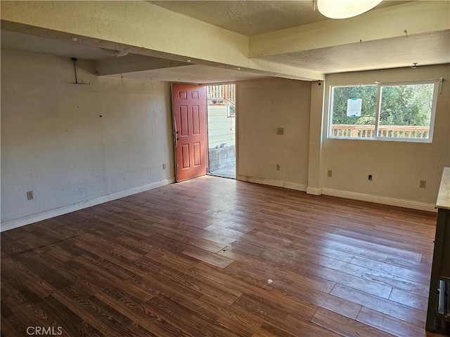 unfurnished room featuring hardwood / wood-style flooring and a textured ceiling