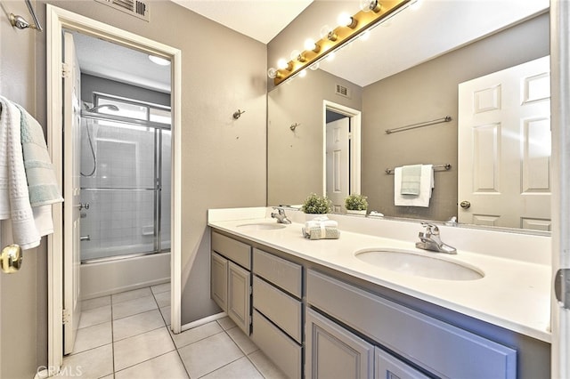 bathroom with enclosed tub / shower combo, vanity, and tile patterned floors