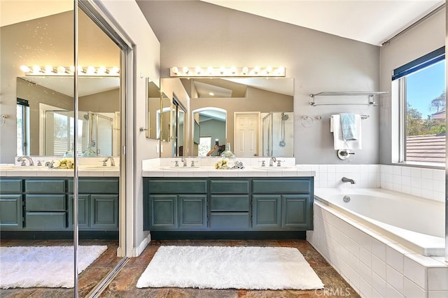 bathroom featuring vanity, vaulted ceiling, and plus walk in shower