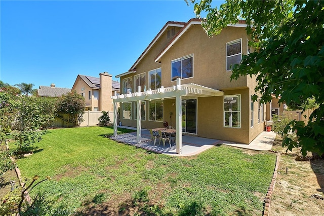 rear view of property with a yard, a pergola, and a patio