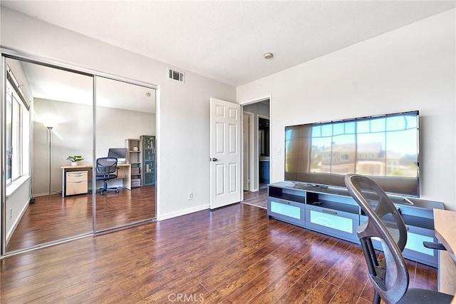 office area with a textured ceiling and dark hardwood / wood-style floors