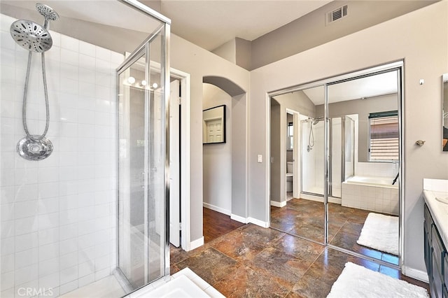 bathroom featuring vanity and separate shower and tub