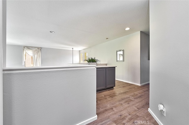 kitchen featuring gray cabinetry and hardwood / wood-style floors