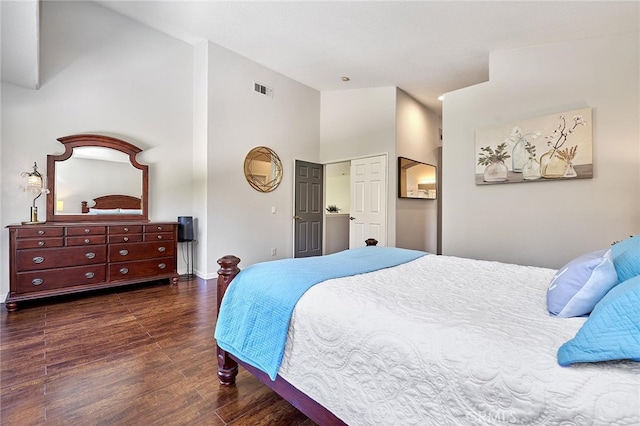 bedroom with dark hardwood / wood-style floors and high vaulted ceiling