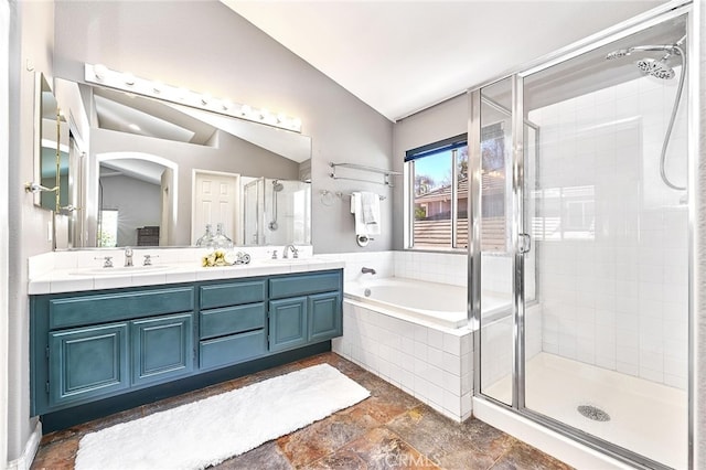 bathroom with lofted ceiling, vanity, and plus walk in shower