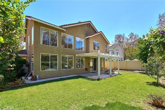 rear view of house with a pergola, a patio area, and a lawn