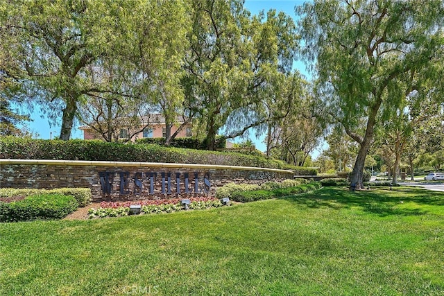 community / neighborhood sign with a lawn