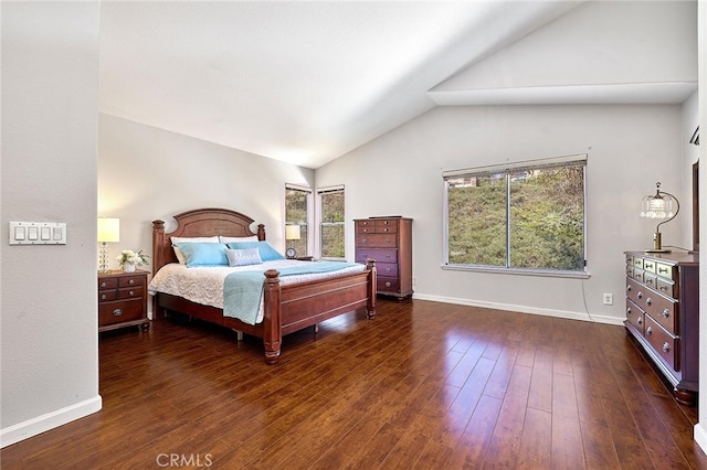 bedroom with vaulted ceiling, multiple windows, and dark hardwood / wood-style flooring