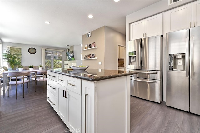 kitchen with dark stone countertops, white cabinetry, dark wood-type flooring, and stainless steel fridge with ice dispenser