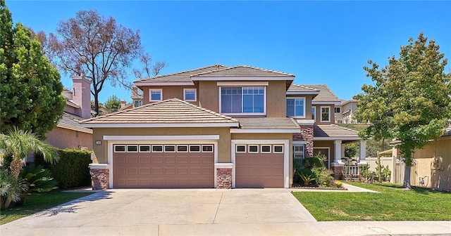 view of front of home featuring a garage and a front yard