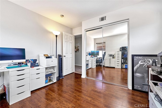 home office featuring a textured ceiling and dark wood-type flooring