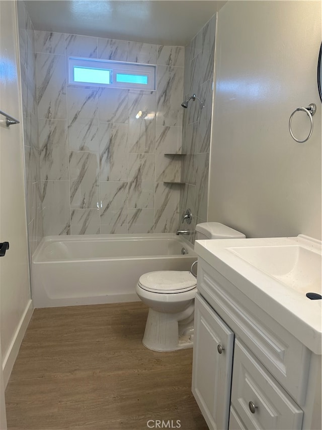 bathroom featuring vanity, bathing tub / shower combination, toilet, and wood finished floors