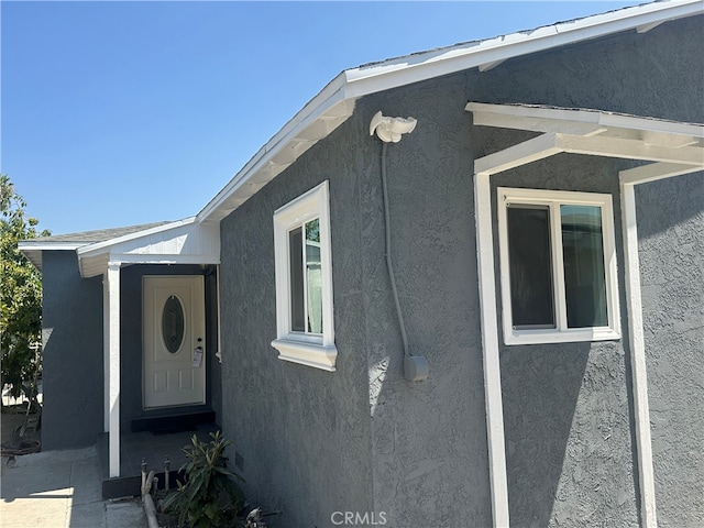 view of side of home featuring stucco siding