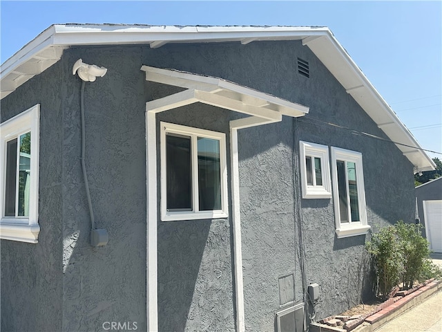 view of side of property featuring stucco siding