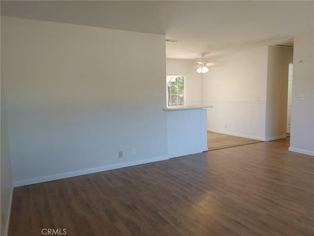 empty room featuring ceiling fan and dark wood-type flooring