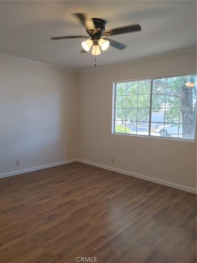 empty room with ceiling fan, dark hardwood / wood-style flooring, and ornamental molding