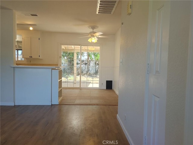 interior space featuring white cabinetry, ceiling fan, and light hardwood / wood-style floors