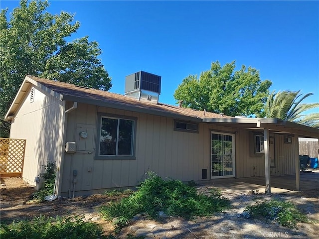 rear view of property with central air condition unit and a patio