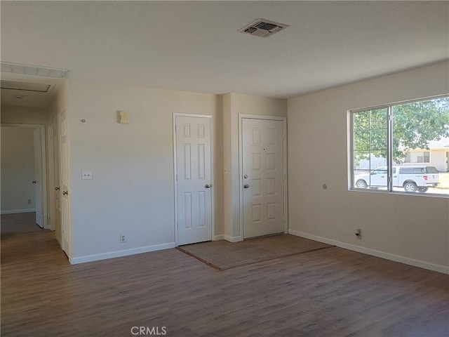 empty room with hardwood / wood-style flooring