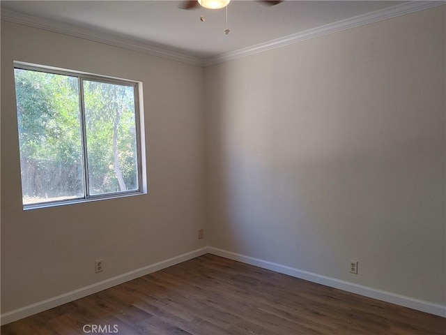 unfurnished room with crown molding, ceiling fan, and dark wood-type flooring