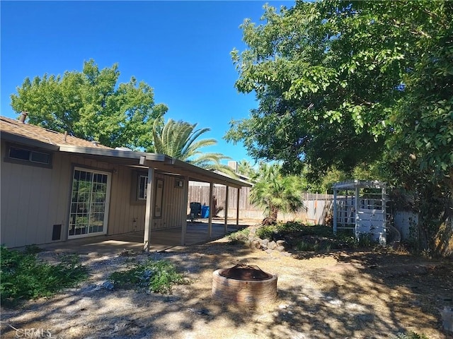 view of yard featuring a patio area and a fire pit