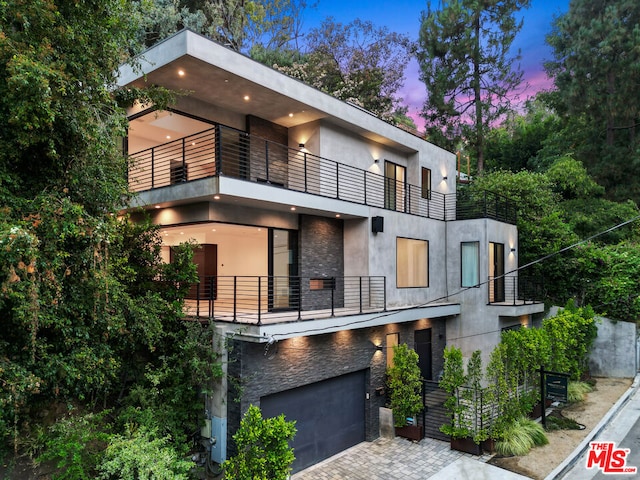 modern home featuring a balcony and a garage