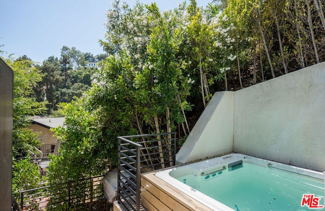 view of pool featuring a covered hot tub