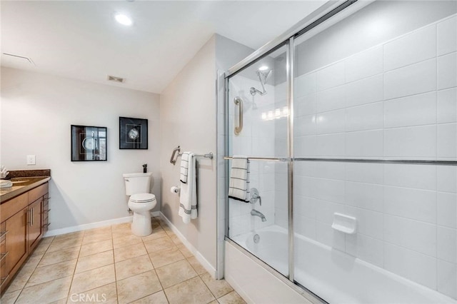 full bathroom with tile patterned flooring, shower / bath combination with glass door, vanity, and toilet