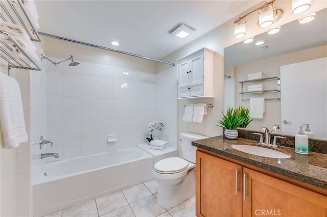 full bathroom featuring vanity, tile patterned floors, tiled shower / bath, and toilet