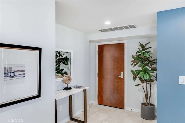 entryway with light tile patterned flooring