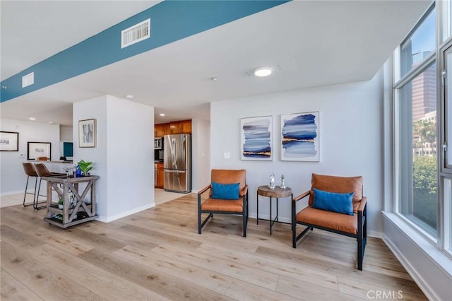 sitting room with light hardwood / wood-style flooring