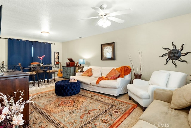 living room featuring a textured ceiling, carpet, and ceiling fan