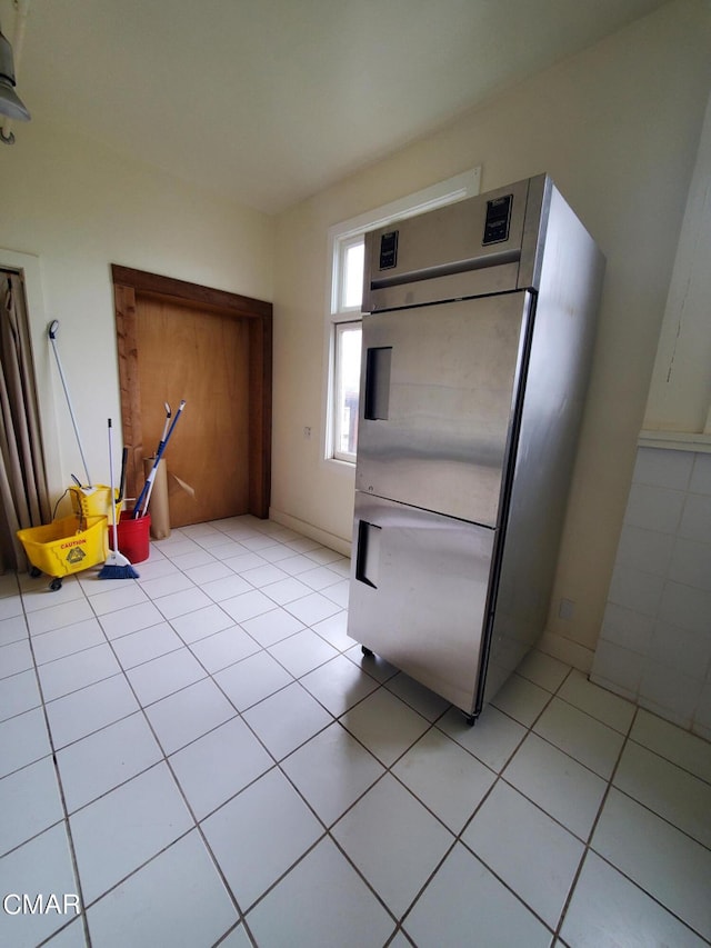 kitchen featuring fridge and light tile patterned floors