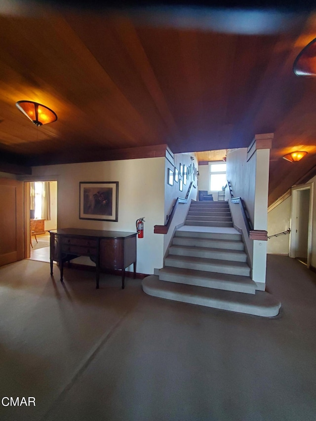 stairs featuring wood ceiling